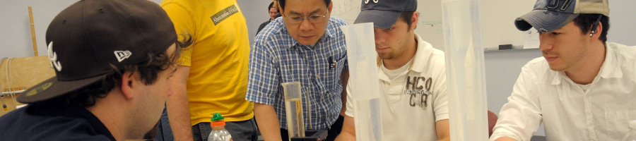 Dr. Van helps some students in lab.