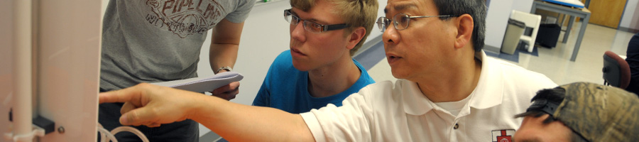Dr. Van helps students in lab.