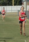 Kayla Hauss checks her time as she crosses the finish line during the Union University Cross Country Invitational. - Photo by Tommy Sadler