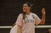 Senior hitter Emilie Ogas shows a smile as she waits for the serve. - Photo by Morris Abernathy