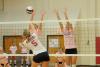 Lady Bulldogs Anna Sims (left) and Amanda Coyle (right) attempt to block a hit by Rhodes (Tenn.) College. - Photo by Morris Abernathy