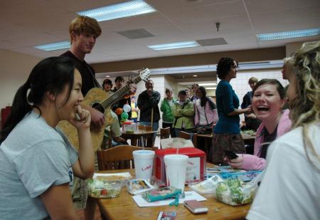 Freshman Chemistry major Ben Wilson serenades freshman Nursing major Megan Daniel during Big-Little week as many other Lambda Chi Alpha members look on.