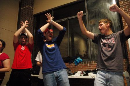 Fans cheer as their water polo team scores a goal during the championship game held by the Wellness Center.