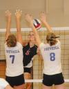 Ashley Young kills the ball into two blockers for a point in the championship match of the TranSouth Conference Tournament. - Photo by Morris Abernathy