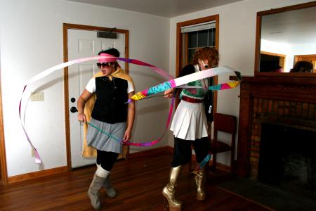 Rose Rogers and Lily Zophi, both senior art majors, twirl the ribbons that are part of their costumes for the art retreat costume party.