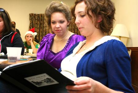 Kelsey Roberts, junior art major, and Ellen Kay, senior art major, look through Kelsey's sketchbook at the annual art retreat.