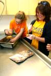 Kelsey Roberts, junior art major, and Alanna Taylor, senior art major, help prepare for dinner at the annual art retreat.  - Photo by Kristi McMurry