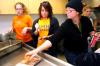 Kelsey Roberts, junior art major, Alanna Taylor, senior art major, and art professors Kathleen Murray and Lori Nolen help prepare for dinner at the annual art retreat.  - Photo by Kristi McMurry