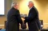 President Dockery presents Jim Bryant his induction plaque for the sports hall of fame. - Photo by Kristi McMurry