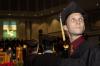 Robert-Matthew Hall, nursing major, searches for his family and friends before the fall graduation ceremony.  - Photo by Beth Spain