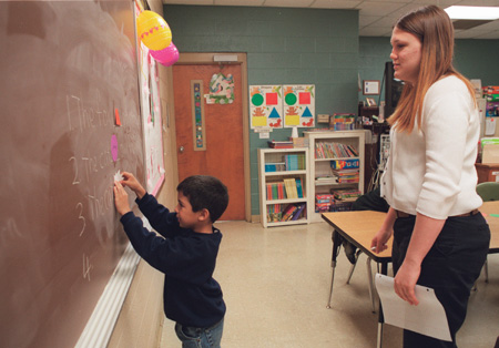 Crane looks on as one of her students fills blanks with correct words on the chalkboard. Crane is the only TESL major student teaching this semester. The TESL major can be fulfilled as a bachelor of arts degree or be joined with the Education Department in order to obtain teaching licensure.