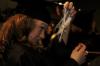 Lily Zopfi, art major, struggles to correct her tassel during the fall graduation ceremony.  - Photo by Beth Spain