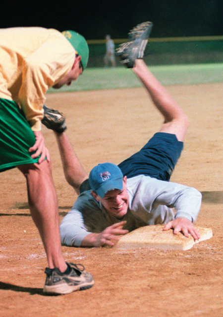 Sophomore Gary Snuffin, Christian ministry and recreation major, slides onto the plate where junior Matt Nason, sports management major, calls the play. Lambda Chi Alpha 2 defeated Onions 1 on Monday, April 21 by a score of 6-5 at the West Jackson Baptist Church softball field.