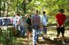Amy Brown, junior Biblical studies major, David Conway, freshman history major, Chad Keathley, junior theology major, and Noah Arnold, junior history major, form a foursome to carry a heavy cedar plank to a drop-off point along the walking trail under construction at Pinson Mounds during Day of Remembrance. - Photo by Kristi McMurry