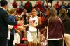 Kaitlin Dudley, junior physical education and health major, runs out to the cheers of fans and teammates at the start of the third game of the Rotary Classic.  - Photo by Kristi McMurry