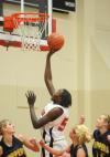 Senior center Josephine Owino lays the ball in the basket over defenders from Blue Mountain (Miss.) College. - Photo by Morris Abernathy