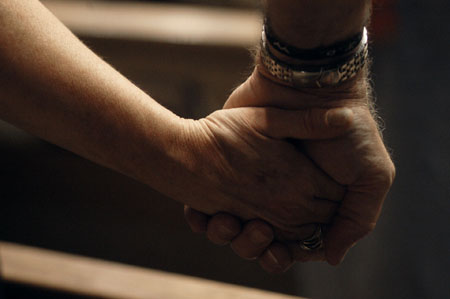 Community members joined hands during prayer at the citywide prayer service held at First Baptist Church, Jackson.