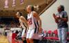 Kaitlin Dudley, Kayla Hudson and Jessica Graves cheer on their team during the semifinals of the 2009 NAIA tournament. - Photo by Kristi McMurry
