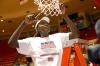 Josephine Owino cuts down a piece of the net at Oman Arena after winning the 2009 NAIA championship. - Photo by Kristi McMurry