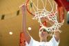 Senior Merideth Richardson Jacobs cuts down a piece of the net at Oman Arena after winning the 2009 NAIA championship. - Photo by Kristi McMurry