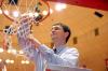 Coach Mark Campbell cuts down a piece of the net at Oman Arena after winning the 2009 NAIA championship. - Photo by Kristi McMurry