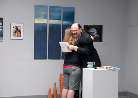 Lee Benson, art department chair, congratulates Paige Ward, junior art major, on her award for the annual student show. Paige won best ceramic piece. 