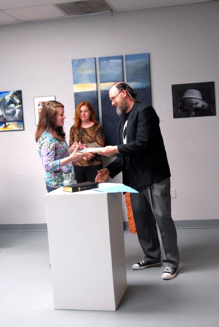 Lee Benson, art department chair, congratulates Kelsey Nagy, sophomore art major, on her scholarship award. 