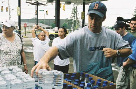Jay Riendour distributes food donated by caring individuals to multiple families during Tornado Relief efforts. 