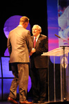 Roy L. White welcomes Peyton Manning to the stage during the Roy L. White Legacy Golf & Gala gala held at the Jackson Civic Center. - Photo by Morris Abernathy