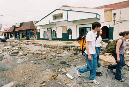Freshmen Jerome Azbell and Brooke Fowler scope out the damage of downtown Jackson on their way to minister. - Photo by Justin Veneman