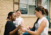 Freshman Shaundra Bloomberg and sophomore Melinda Eckley hand out bottled water to Jackson residents who were affected by the May 2003 tornado. - Photo by Justin Veneman