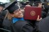 Austin McClain shows off his diploma after walking the stage during the spring graduation ceremony on Saturday, May 23, 2009. - Photo by Beth Spain