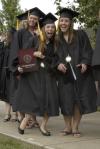 Alaina Baire and Jessica Bandy celebrate as they make their way to the Great Lawn for spring graduation. - Photo by Sarah Palmer