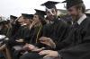 Graduate Kieler Henry and Josh Henson have trouble with the wind and their tassels during spring graduation. - Photo by Sarah Palmer