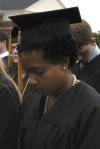 Amber-Rose Hawkins prays with President Dockery and the rest of the graduates during spring graduation. - Photo by Sarah Palmer