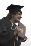 Theatre graduate Natalie Newberry celebrates as she receives her diploma during spring graduation. - Photo by Sarah Palmer