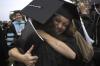 Heather Childers hugs Ashley Deihm after the spring graduation ceremony. - Photo by Sarah Palmer