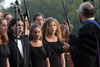 Dr. Richard Joiner leads the University Singers at Spring Graduation 2003. - Photo by Jim Veneman