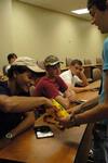 Sam Ridder, sophomore piano performance major, gives out candy to Will Thomas, freshman pre-pharmacy major, as part of a new student orientation icebreaker. - Photo by Sarah Palmer