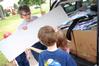 Dottie Myatt, professor of education, and her family helps unload an incoming freshman's car on move-in day. Many faculty, staff, and students came to help. - Photo by Kristi McMurry