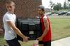Jake Carter (on left), freshman on the soccer team, and Sophomore Jose Marroquin help new students move into the Heritage Complex. - Photo by Beth Spain