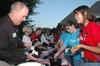 Mark Kahler, assistant vice president for university communications, serves ice cream to junior Haley Gallagher during an ice cream social at President Dockery's house during new student orientation. - Photo by Beth Spain