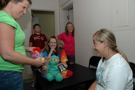 Rebecca Green, sophomore math major, receives a toy bear and nurse kit from her roommates mother Michelle Fry during returning student move-in day.