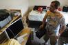 JR Villers, junior DMS major, debates on where to arrange things in his room. - Photo by Sarah Palmer