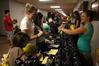 Danielle Blackstone, senior biology major, hands out water bottles to freshmen Sara Tate and Megan Pace at the organization fair.           - Photo by Sarah Palmer