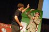 Zach Preston, freshman, high-fives the host of the SAC Game Show after winning an iPod nano. - Photo by Kristi McMurry