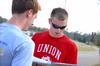 Blake Pennington, intramural director, signs Andrew Griffith, senior business administration major, in to play the football toss competition.  - Photo by Kristi McMurry