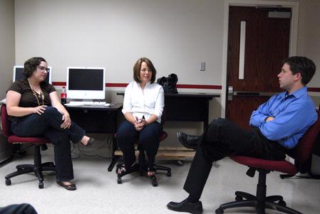 Melinda Eckley, assistant professor of art, and Kathy Chute, associate professor of communication arts, conduct an American Advertising Federation meeting with Steve Chandler.