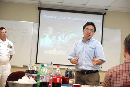 Haifei Li, professor of computer science, introduces the speaker from the Navy for an ACM meeting.