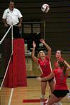 Katie Adams, senior communications major, sets the ball as Anna Sims, sophomore art major, approaches to spike it.  The Lady Bulldogs won this match against Martin Methodist 3-0. - Photo by Kristi McMurry